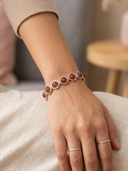 Vintage silver-tone bracelet with round orange cabochon stones and geometric link design.